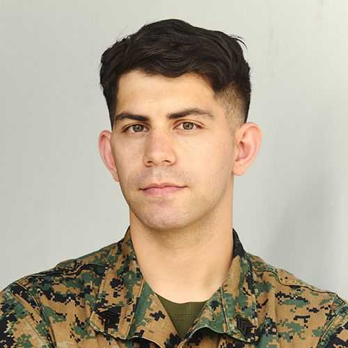 Man in U.S. Marine Corps uniform smiling and facing forward