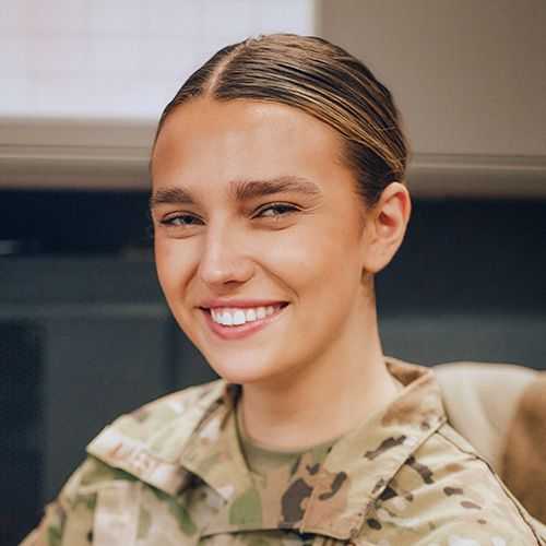 Woman in U.S. Air National Guard uniform smiling and facing forward