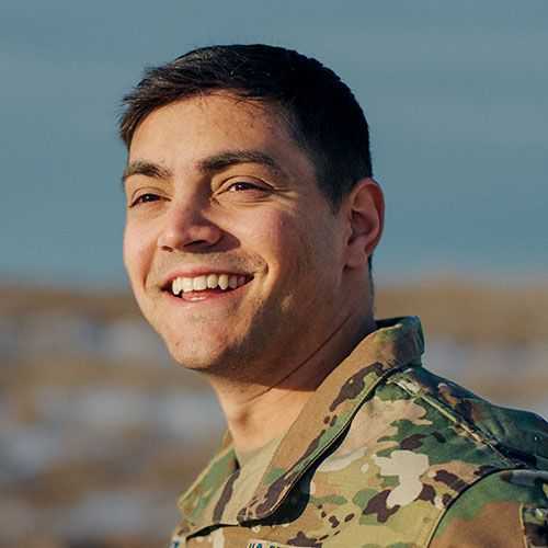 Man in U.S. Space Force uniform smiling and facing towards his right