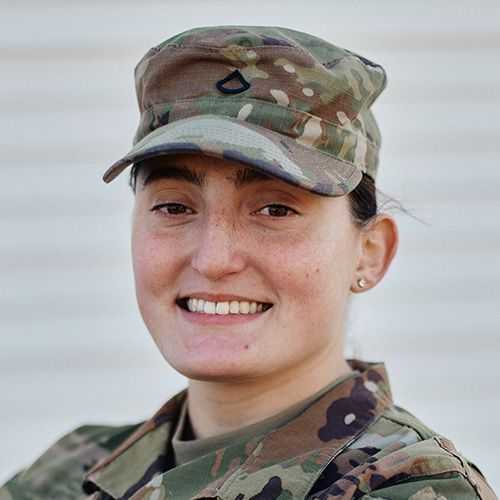 Woman in U.S. Army National Guard uniform smiling and facing forward