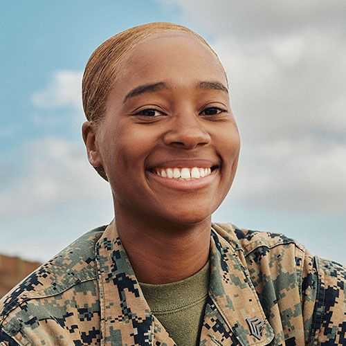 Woman in U.S. Marine Corps uniform smiling and facing forward