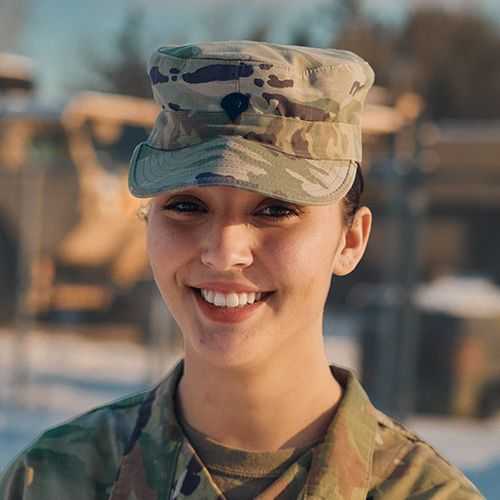 Woman in U.S. Army National Guard uniform smiling and facing forward